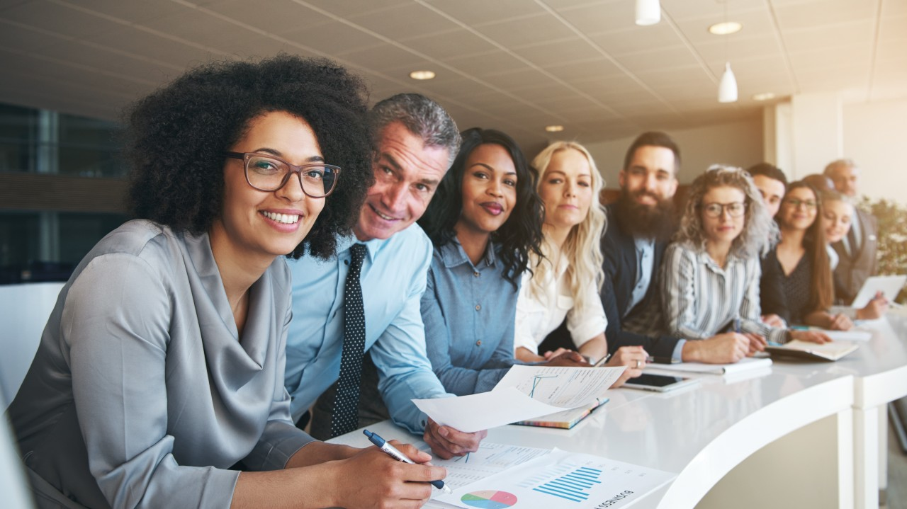 Colleagues collaborating around a table in the workplace